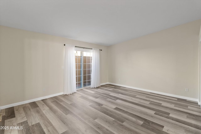 unfurnished room with light hardwood / wood-style flooring