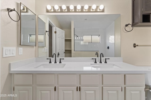 bathroom featuring a shower and vanity