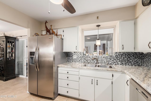 kitchen featuring tasteful backsplash, ceiling fan, appliances with stainless steel finishes, white cabinetry, and a sink