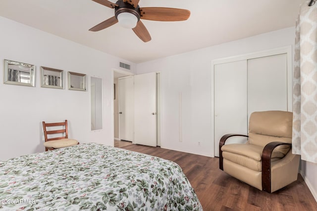 bedroom with ceiling fan, a closet, visible vents, and wood finished floors