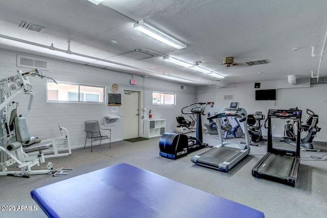 gym with visible vents and a textured ceiling