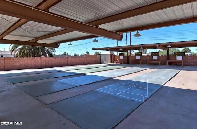 view of home's community featuring shuffleboard and fence