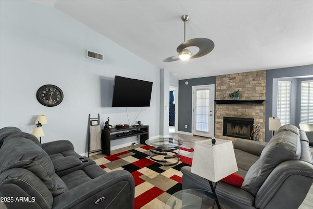 living room featuring ceiling fan, wood-type flooring, a fireplace, and high vaulted ceiling