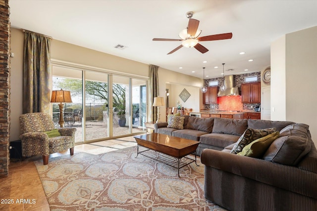 living room with light tile patterned floors and ceiling fan