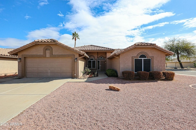 mediterranean / spanish-style house featuring a garage