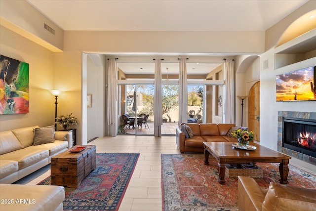 living room with a tiled fireplace