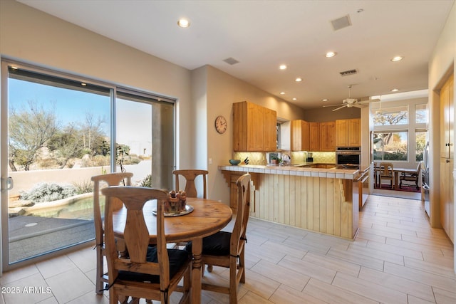 dining area with ceiling fan