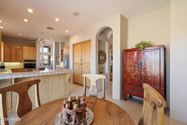 dining area featuring ceiling fan and light hardwood / wood-style floors