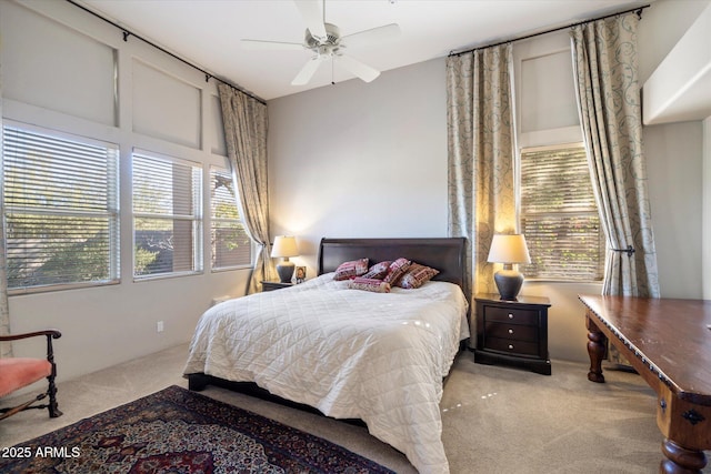 carpeted bedroom with multiple windows and ceiling fan