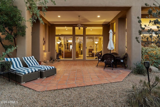 view of patio with ceiling fan and an outdoor living space