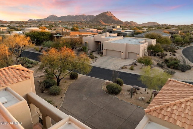 aerial view at dusk featuring a mountain view