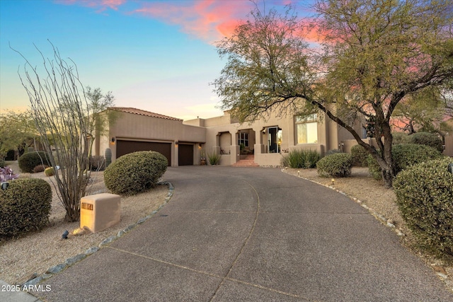 southwest-style home with a garage