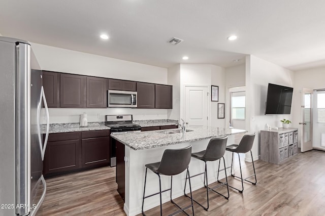 5875 N 195th Dr, Litchfield Park, AZ 85340 - kitchen with light wood-type flooring, visible vents, appliances with stainless steel finishes, and a sink