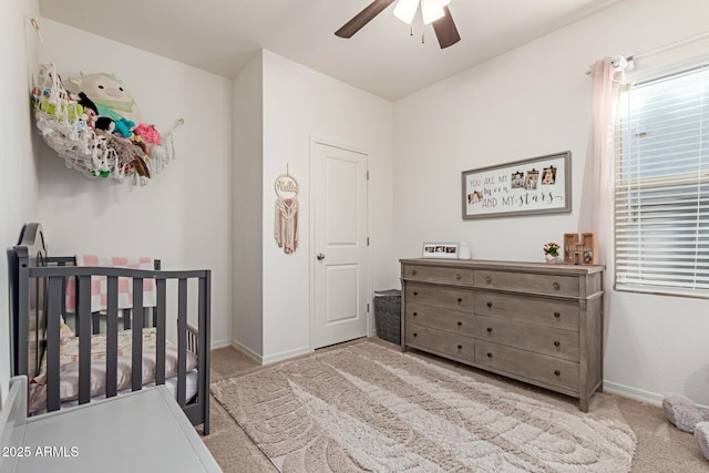 5875 N 195th Dr, Litchfield Park, AZ 85340 - carpeted bedroom featuring ceiling fan, a crib, and baseboards