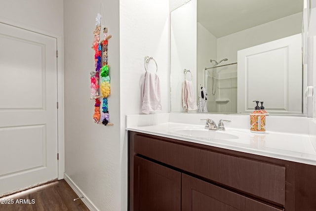 5875 N 195th Dr, Litchfield Park, AZ 85340 - bathroom with wood finished floors, vanity, baseboards, and walk in shower