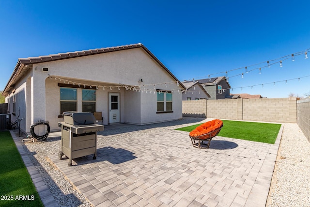 5875 N 195th Dr, Litchfield Park, AZ 85340 - rear view of house featuring a patio, a fenced backyard, central AC, a tile roof, and stucco siding