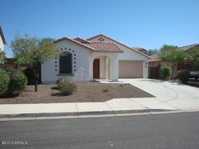 mediterranean / spanish-style house with a garage