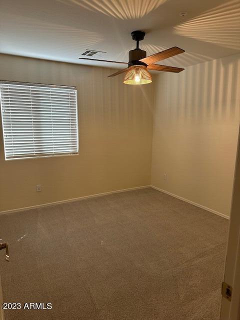 carpeted empty room with ceiling fan