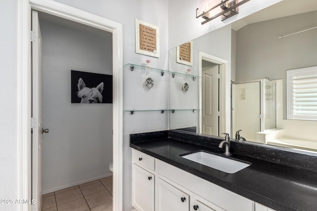 full bathroom featuring toilet, a shower stall, vanity, and tile patterned floors