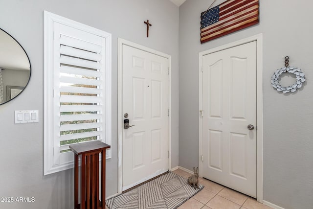 entrance foyer with baseboards and light tile patterned flooring