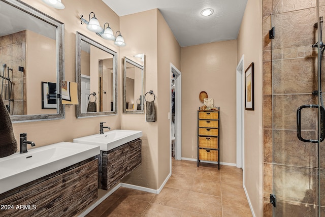 bathroom featuring tile patterned floors, vanity, and walk in shower