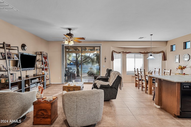 tiled living room featuring ceiling fan