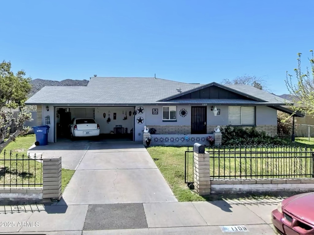 ranch-style home with a garage and a front yard