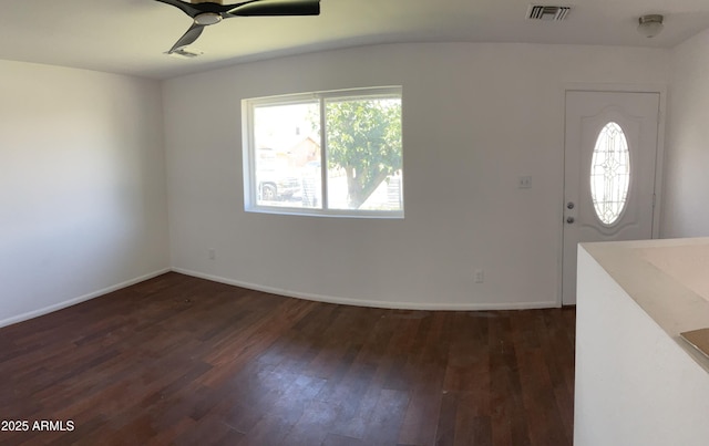 foyer with baseboards, a ceiling fan, dark wood finished floors, and visible vents