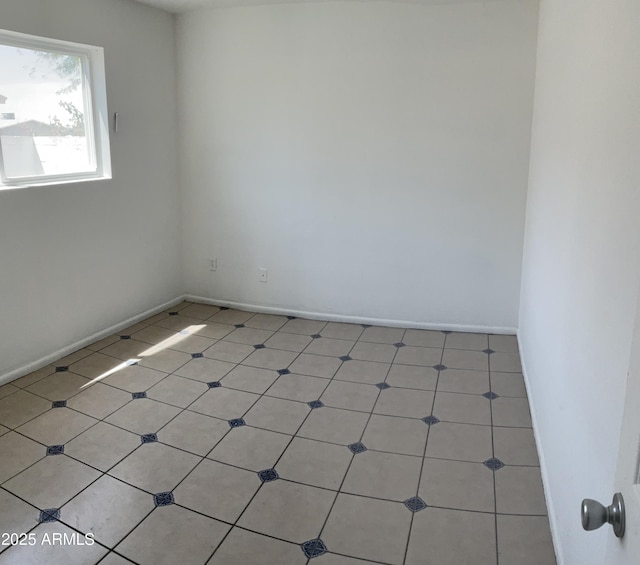 unfurnished room featuring baseboards