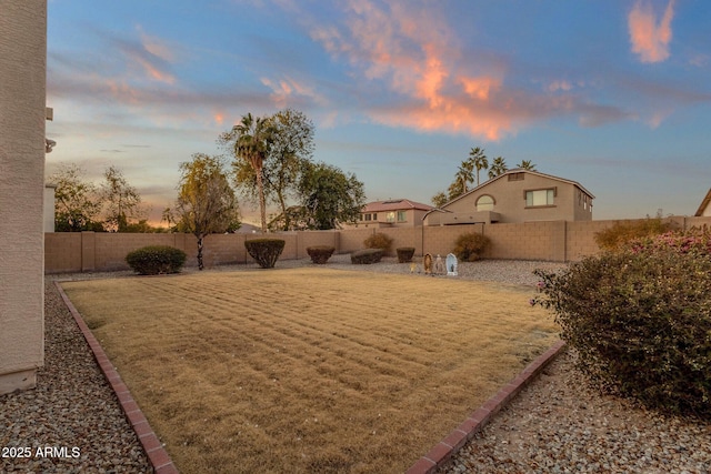 view of yard at dusk