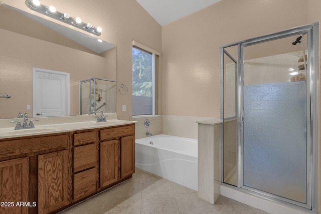 bathroom featuring tile patterned floors, shower with separate bathtub, vaulted ceiling, and vanity