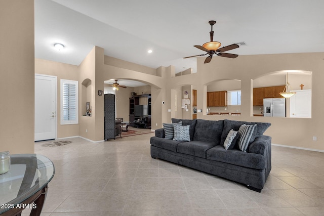 tiled living room with vaulted ceiling and ceiling fan