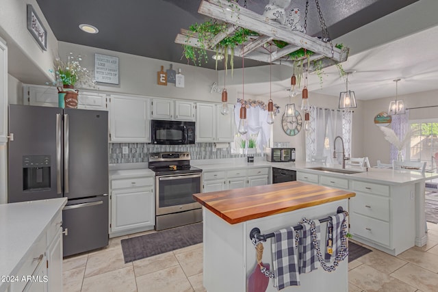 kitchen featuring black appliances, a kitchen island, sink, and white cabinets