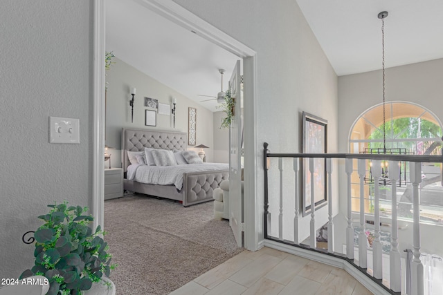 bedroom featuring lofted ceiling and light colored carpet