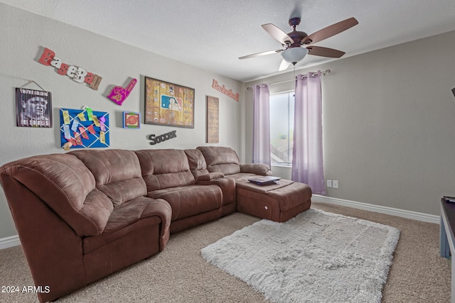 living room with ceiling fan, carpet floors, and a textured ceiling