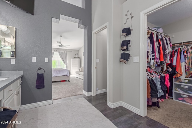 bathroom with wood-type flooring, vanity, and ceiling fan