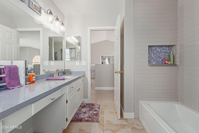 bathroom with vanity, a bathing tub, and vaulted ceiling