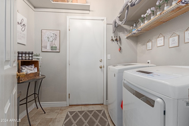 clothes washing area with light tile patterned floors and independent washer and dryer