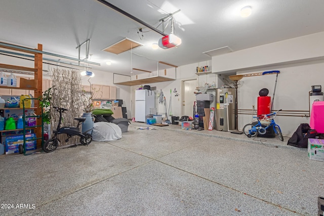 garage featuring water heater, a garage door opener, and white refrigerator