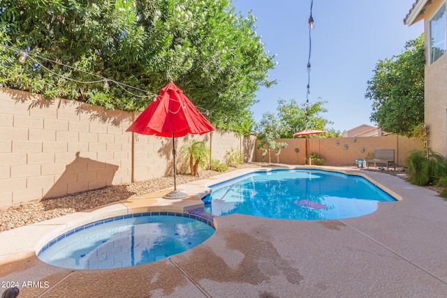 view of pool featuring a patio and an in ground hot tub