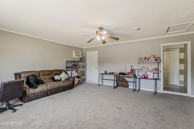 carpeted living room with crown molding, a ceiling fan, a textured ceiling, and attic access