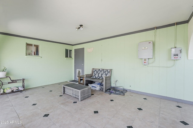 spare room featuring light tile patterned floors and crown molding