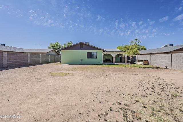 back of property featuring a fenced backyard