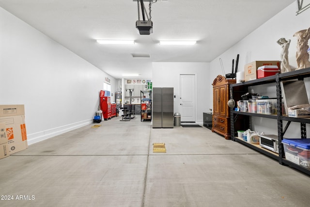 garage with baseboards and a garage door opener
