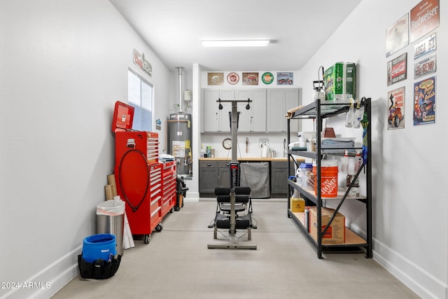 workout room featuring baseboards and gas water heater