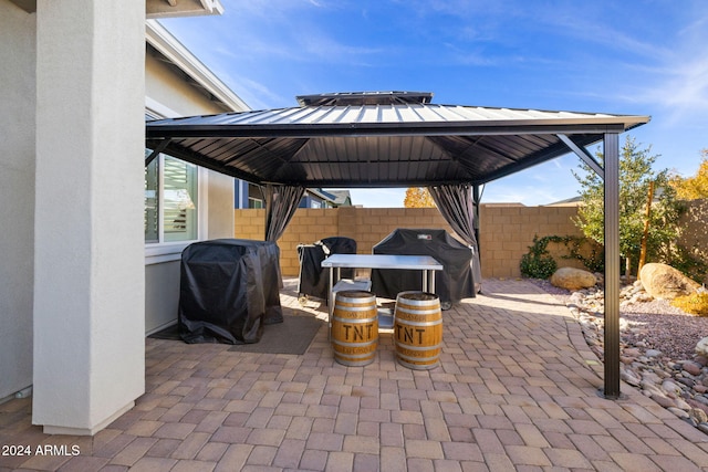 view of patio with a gazebo, area for grilling, and fence