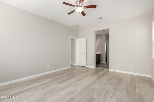 unfurnished bedroom with visible vents, baseboards, light wood-style floors, and connected bathroom