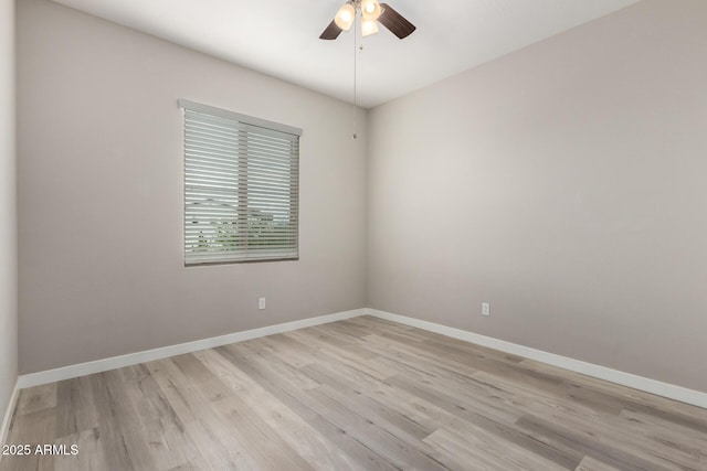 unfurnished room featuring baseboards, light wood-style floors, and ceiling fan