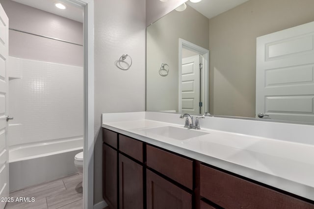 bathroom with shower / tub combination, toilet, and vanity