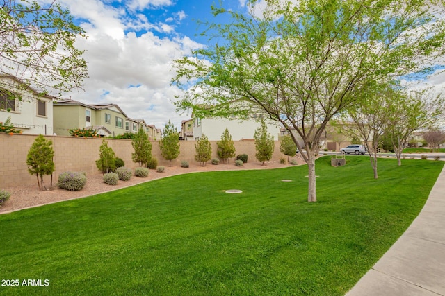 surrounding community featuring a residential view, a lawn, and fence